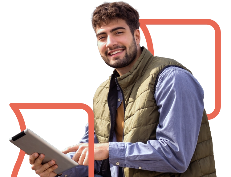 Young male farmer using smart tablet while smiling