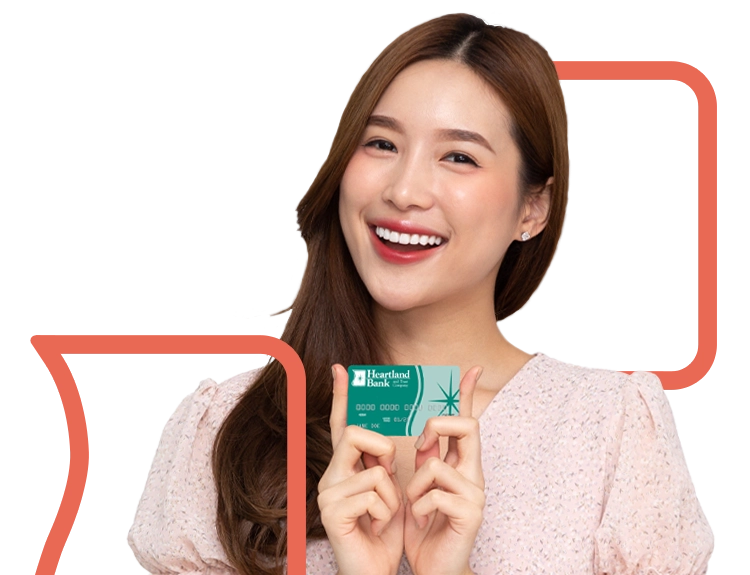 Young adult woman holding Heartland Bank and Trust Company Debit Card