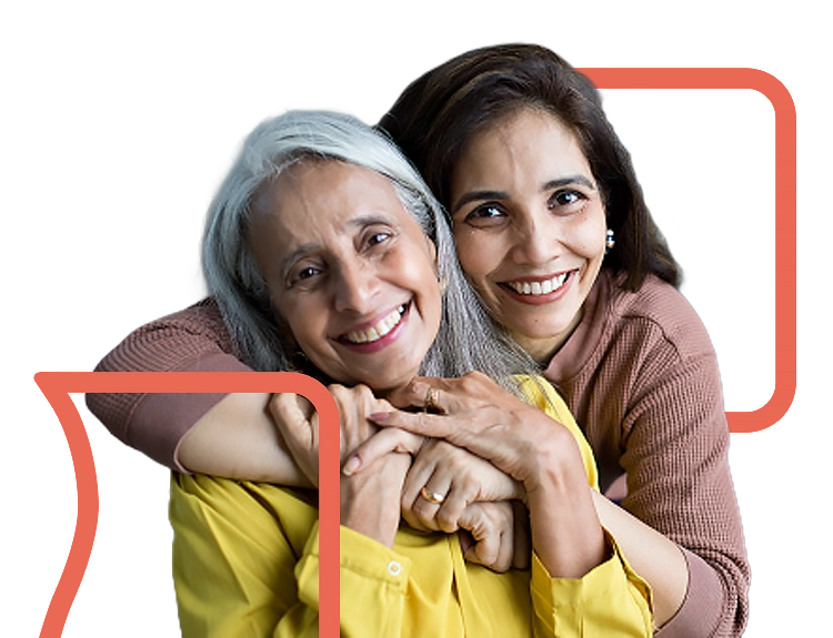 Adult daughter hugging elder mother from behind and smiling