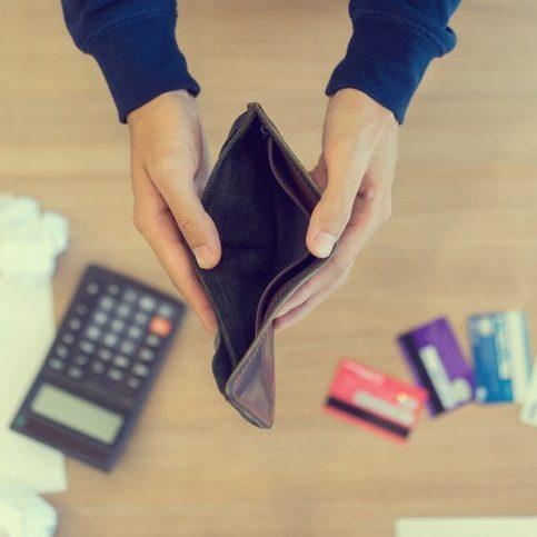 a person holding an empty wallet