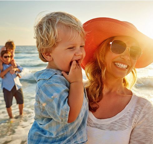 a woman and a child on the beach